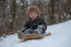 A cheerful child enjoying the thrill of sledding down a snowy hill on a crisp winter day in a serene wooded area photo