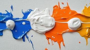 Blue, white, orange paint swirls on canvas. Art background texture photo