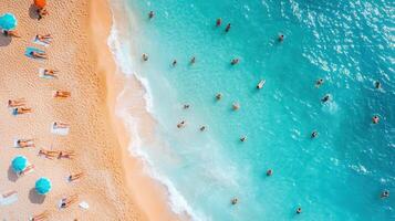 Aerial view of crowded beach, turquoise water, sunbathers, swimmers photo