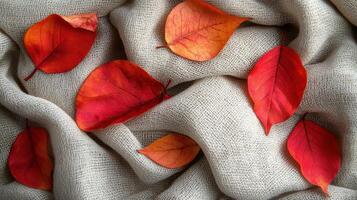 Autumn leaves on beige fabric, cozy fall background, textile texture photo