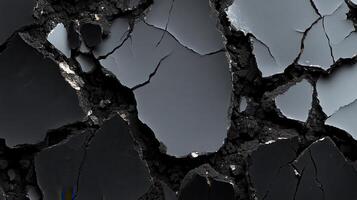 Cracked dark surface, abstract texture background photo