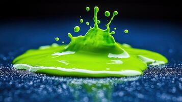 Green paint splash, dynamic impact, dark background, vibrant color, design element photo