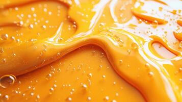 Orange liquid flowing, bubbles, close-up, texture, cosmetic background photo