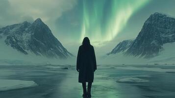 Person gazing at aurora borealis over icy Arctic mountains photo