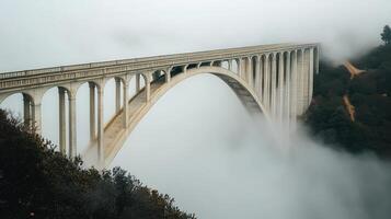 Foggy arched bridge over valley, scenic drive photo