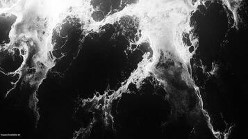 White foam swirls on black background, abstract art photo