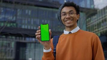 Smiling Man Nodding in Approval Holding Chroma Key Smartphone video