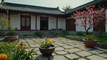Serene view of traditional Asian courtyard with blooming flowers and architecture. photo