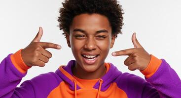 Cheerful African American boy winking and pointing fingers at the camera photo