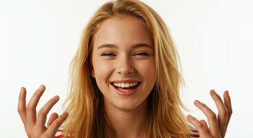 Excited young woman laughing with hands up against a white backdrop photo