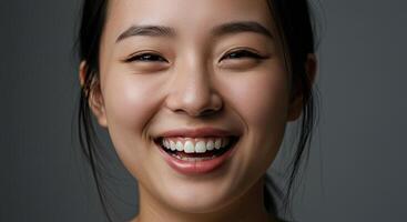 Portrait of radiant Asian woman with beaming smile showcasing perfect teeth photo