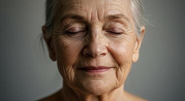 Serene elderly woman with closed eyes in quiet contemplation portrait photo