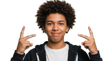 Smiling African American teen pointing fingers up on white background photo