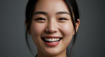 Smiling Asian woman portrait with perfect teeth and glowing skin photo