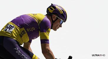 Professional cyclist in action wearing purple and yellow racing gear photo