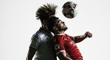 Two soccer players headbutting the ball in a dynamic action shot against white background photo