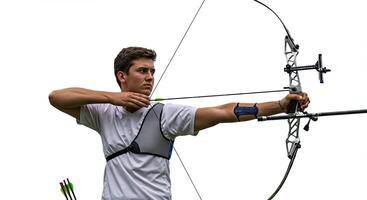 Young man archer aiming bow and arrow during outdoor archery practice photo