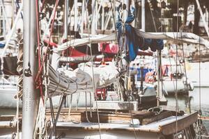 Sailboats in harbor with coiled ropes and nautical details, background photo