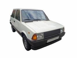 Classic compact car parked on a clean, bright day with clear skies and minimal background distractions photo