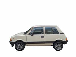 Classic white compact car parked against a plain background showcasing its distinctive design and features photo