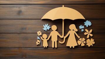 Paper cut of family with umbrella on wooden background photo