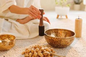 Sound therapy ritual with Tibetan bowl and healing tools in a serene spiritual setting. photo