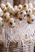 This delightful arrangement features quail eggs carefully crafted into a stunning Easter decoration. Perfect for home decor, it adds a touch of rustic charm and seasonal joy to any setting. photo
