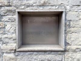Stone niche in gray textured wall for architectural design or display photo