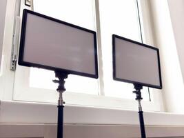 Dual rectangular led panel lights in front of a bright window photo