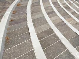 Curved stone pavement with white stripes in urban setting photo