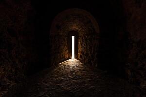 Mystical Stone Corridor Illuminated by Light Through an Open Doorway photo