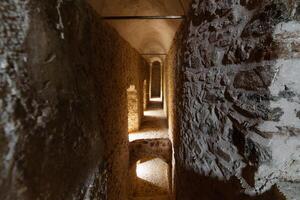 Historic castle Stone Corridor with Atmospheric Lighting photo