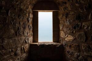 Mystical Stone Corridor Illuminated by Light Through an Open window photo