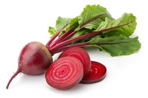 Fresh beetroot root with three slices and vibrant green leaves are arranged neatly photo