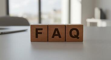 Wooden FAQ Blocks on a White Tabletop with Blurred Background photo