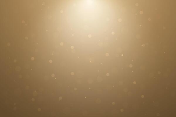 Golden soft bokeh background with light glow from top center