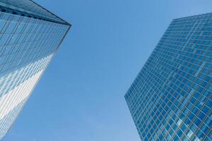 Modern office opposite two building high rise in city urban business area in clean blue sky photo