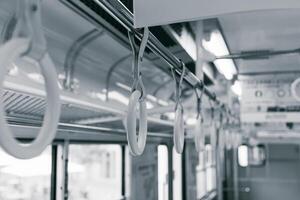 Closeup subway underground train passenger handle ring hand grip for stable standing in the cabin photo
