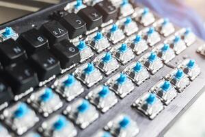 A close up of a keyboard with blue buttons photo