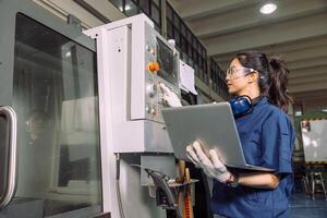Female Technician Working with Precision on Lathe Machine in Industrial Setting photo