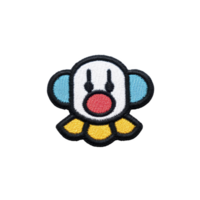 Colorful embroidered patch features cartoon clown face with red nose, blue ears, and yellow collar, set against transparency background png