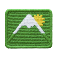 Green embroidered patch features stylized white mountain with yellow sun peeking over its peak, symbolizing adventure and nature. design is simple yet vibrant png