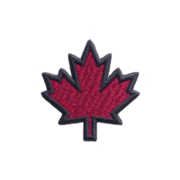 Red maple leaf patch with black border, symbolizing Canada, is depicted on plain background. design is simple and iconic, representing Canadian identity and pride png