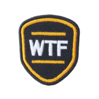 Black and yellow embroidered patch features bold letters WTF in white, creating humorous and edgy design. patch is shield shaped, with yellow border and two horizontal lines above and below text png