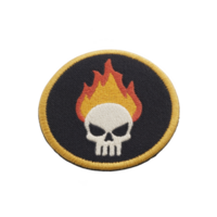 Round embroidered patch features skull with flames on transparency background, bordered by yellow edge. design is bold and striking, suitable for jackets or bags png