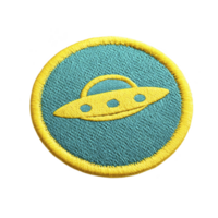 Round embroidered patch features yellow UFO design on teal background, bordered by yellow edge. playful and colorful design evokes sense of curiosity and adventure png
