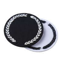 Two round embroidered patches, one black and one white, featuring laurel wreath design. patches are stacked, showcasing contrasting colors and intricate stitching png