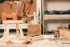A table with a stool, tools and other items on it photo