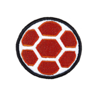 A This features circular embroidered patch with red hexagonal pattern resembling soccer ball. patch has white border around hexagons and black outer edge, giving it sporty and vibrant appearance png