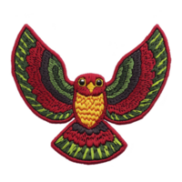 A vibrant embroidered patch features colorful bird with outstretched wings, showcasing intricate patterns in red, green, and yellow threads. design is bold and eye catching png